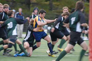 Queen’s inside centre Graeme Whyte breaks through a pack of Trent players.