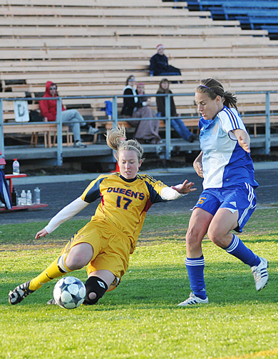 Gaels’ midfielder Erin Smith slides to clear the ball against Ryerson’s Susanne Briggs Saturday.