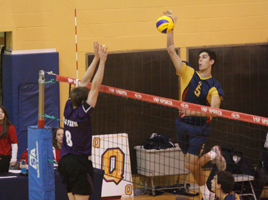 Gaels’ outside hitter Joren Zeeman (5) goes for a kill against Western’s Reid Halpenny Saturday.