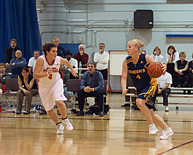 Queen’s guard Lyndsay Gauley drives against RMC’s Julie-Christine Lasalle Friday.