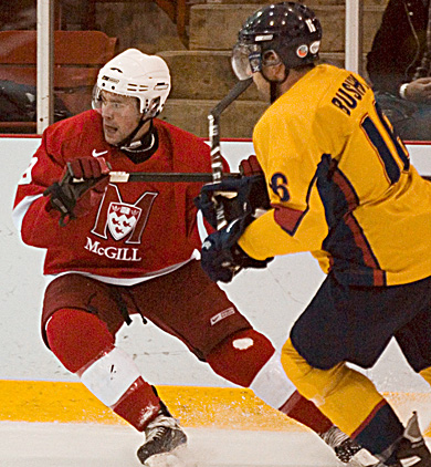 Queen’s defenceman Mike Bushby battles McGill’s Alexandre Picard-Hooper Saturday. The Gaels lost 4-1.