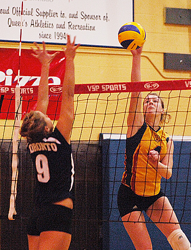 Queen’s outside hitter Lorna Button tips the ball Friday night at Bartlett Gym against U of T’s Heather Bansley. The Gaels lost in five sets.