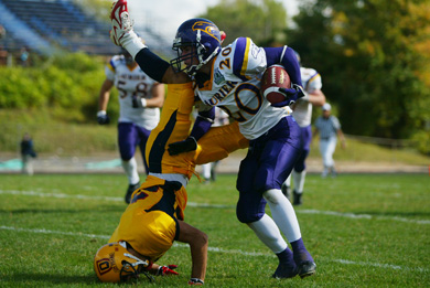 Queen’s defensive back Addison Rich gets turned on his head in last year’s match-up against Laurier on September 29