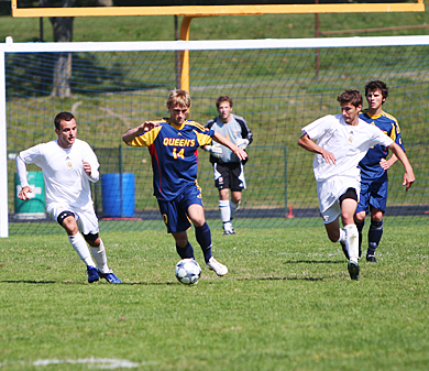 Queen’s defender Jordan Brooks evades several Laurentian players Sunday at Richardson Stadiums as goalkeeper Tyler Lewis and fellow defender Chris Deckert (2) look on.