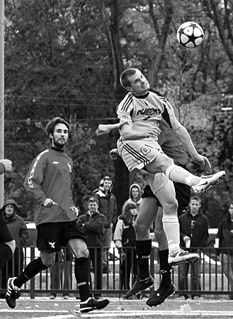 Midfielder Nathan Klemencic rises for a header.