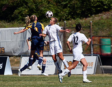 Striker Kelli Chamberlain (left) goes up for a header during the Gaels’ 3-1 win over Nipissing on Sept. 20. Chamberlain scored two goals against Laurier during Friday’s 3-2 semifinal win.
