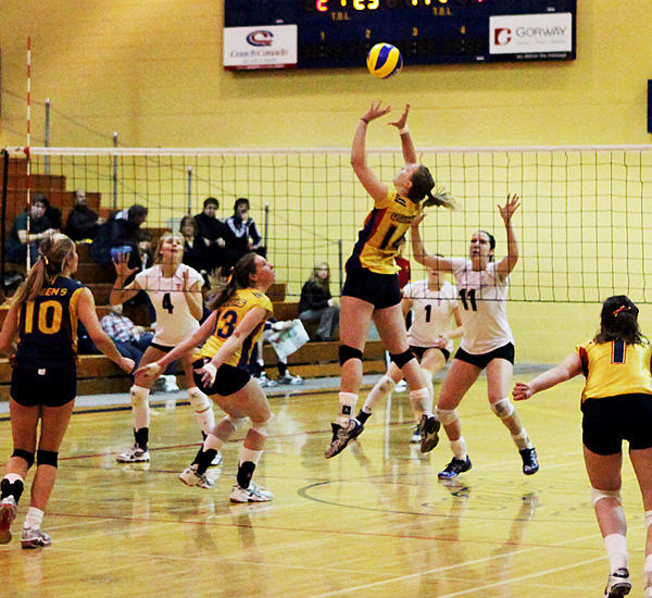 Setter Kristin Collins lays up the ball for middle hitter Katie Matthews during the Gaels five-set victory over the Varsity Blues at Bartlett Gym