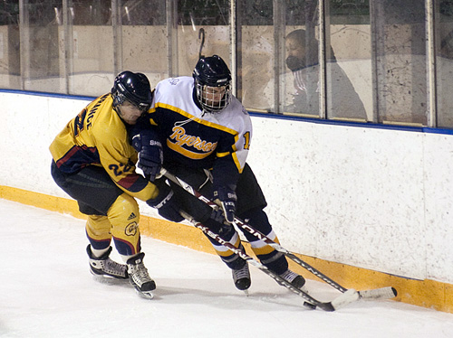 Gaels forward Jon Lawrance holds up a Ryerson defenseman during Saturday’s 9-5 shellacking at the hands of the Rams.