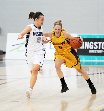 Guard Brittany Moore charges down the court while battling a Mustang player on Saturday.