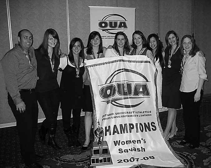 The women’s squash team pose with their OUA banner.